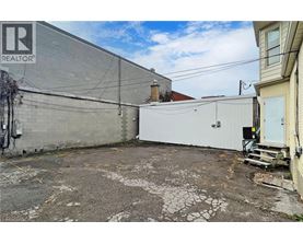 A grey building with a sign that says REALTOR.