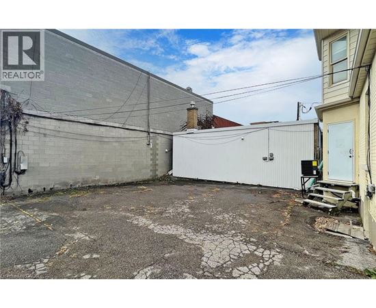 A grey building with a sign that says REALTOR.