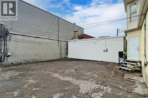 A grey building with a sign that says REALTOR.