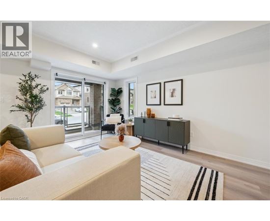 A living room with a white couch and a grey cabinet.