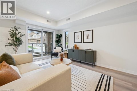 A living room with a white couch and a grey cabinet.