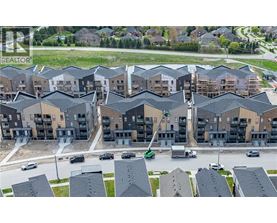 A large apartment complex with multiple buildings and cars parked in the driveways.