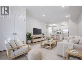A well-lit, modern living room with a television, couches, and a coffee table.