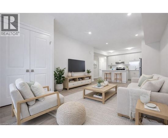 A well-lit, modern living room with a television, couches, and a coffee table.