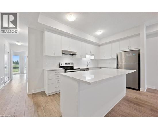 A modern kitchen with white cabinets and a large island.