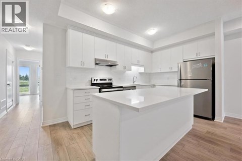 A modern kitchen with white cabinets and a large island.