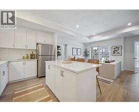 A modern kitchen with white cabinets and a central island.