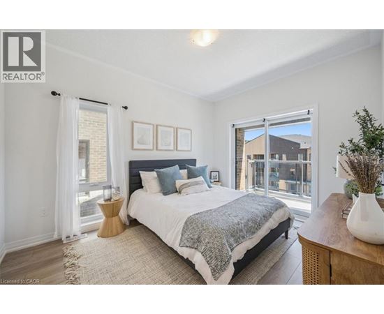 A bedroom with a large bed and a view of a balcony.