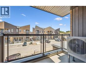 A view from a balcony overlooking a parking lot and a building with the logo REALTOR.