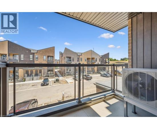 A view from a balcony overlooking a parking lot and a building with the logo REALTOR.