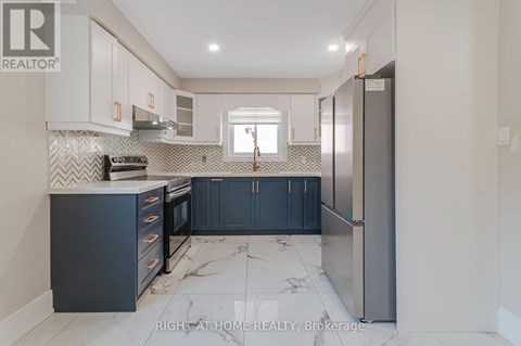 A kitchen with a marble floor and a refrigerator on the right.