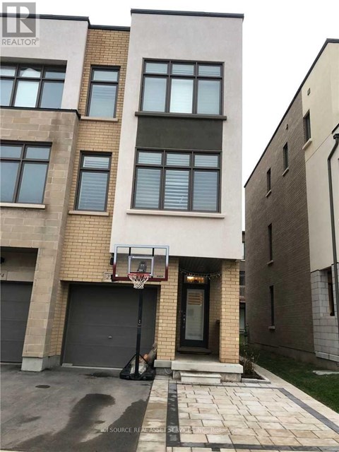 A basketball hoop is attached to the side of a building.