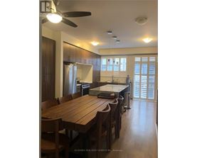 A kitchen with a table and chairs in front of a window.