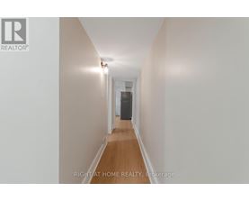 A long hallway with a door at the end.