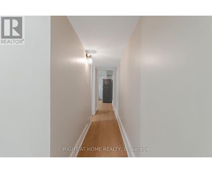A long hallway with a door at the end.