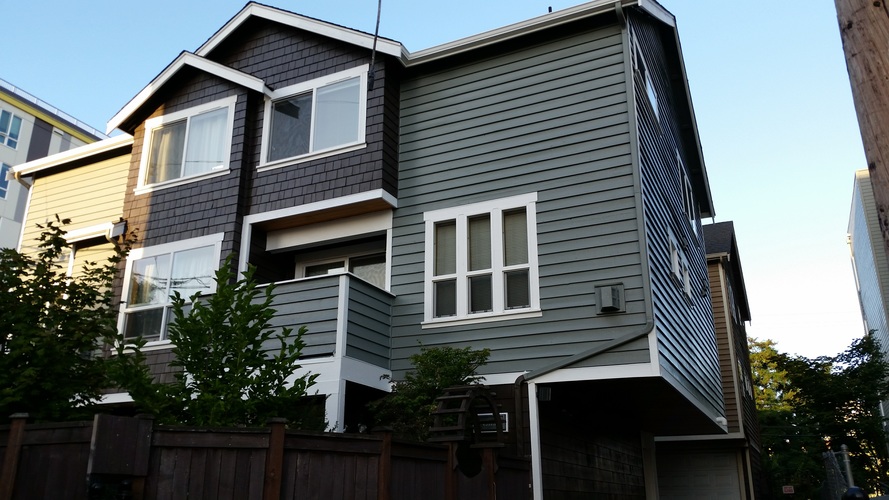 A grey house with a white window.