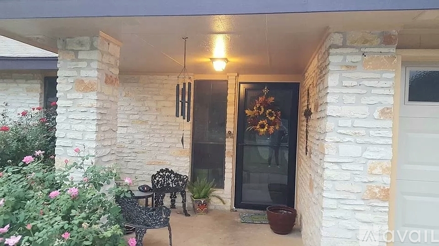 A patio with a table and chairs is visible through a glass door.