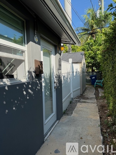 A house with a grey exterior and a white door.