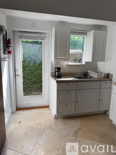 A kitchen with a sink and a window.