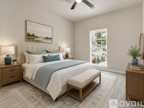 A bedroom with a large bed, a bench, and a painting on the wall.