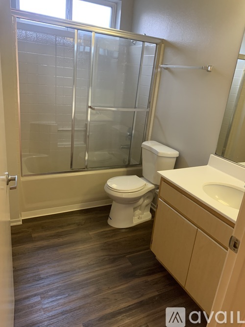 A bathroom with a toilet, sink, and shower.