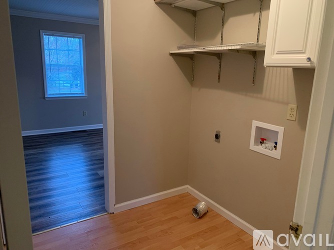A kitchen with a white stove and a window with bars.