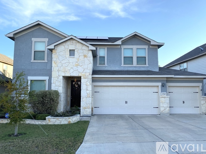 A house with a stone pillar entrance and a garage door.