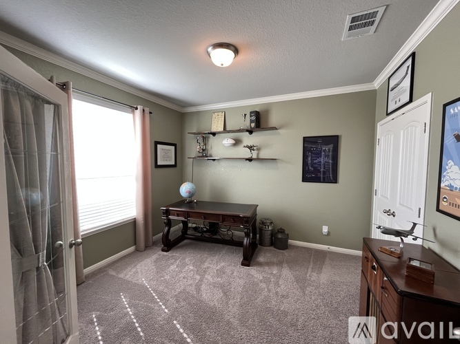 A living room with a sofa, a table, and a window with curtains.