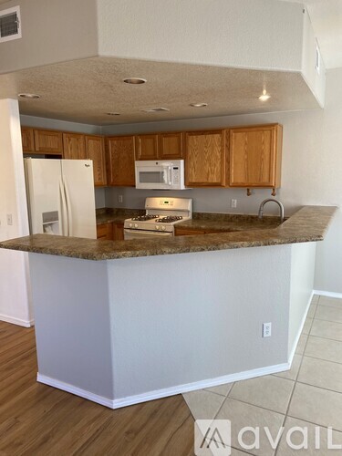 A kitchen with wooden cabinets and a granite countertop.