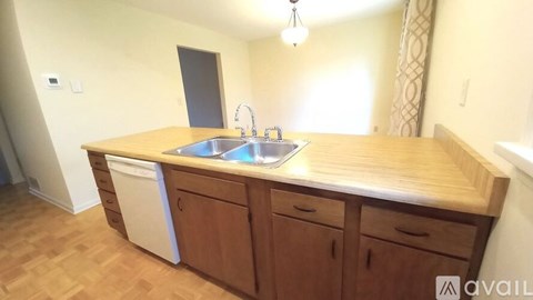 A kitchen with wooden cabinets and a sink.