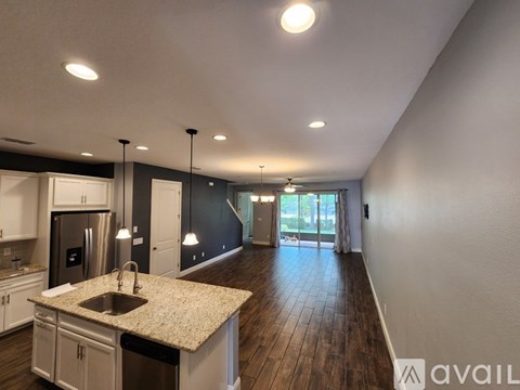 A kitchen with a granite countertop and a sink.