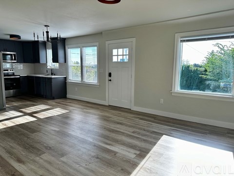 A kitchen with dark wood cabinets and a white door.