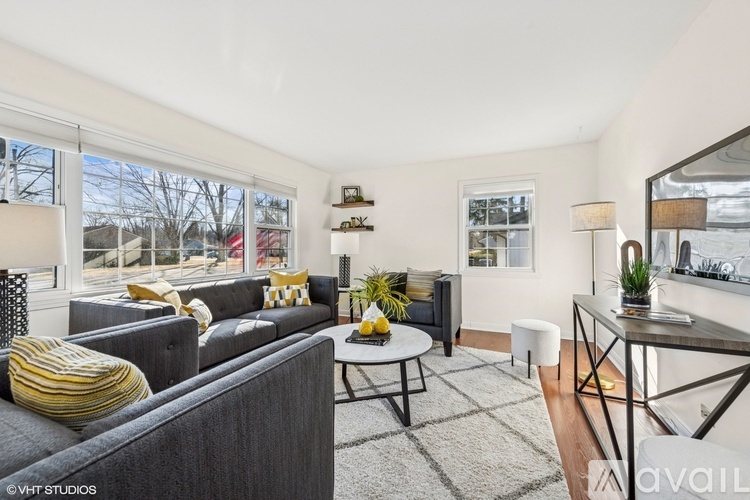 A living room with a grey couch and a coffee table.