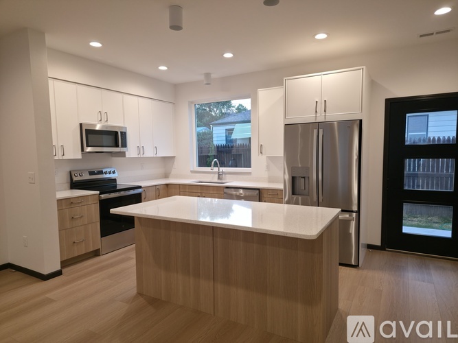 A modern kitchen with wooden cabinets and stainless steel appliances.