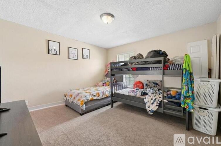 A bedroom with a bunk bed and a single bed.