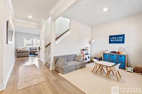 A living room with a grey couch and a blue cabinet.
