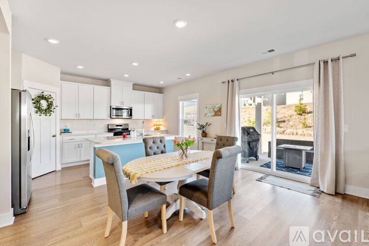 A modern kitchen with a dining table set for four.