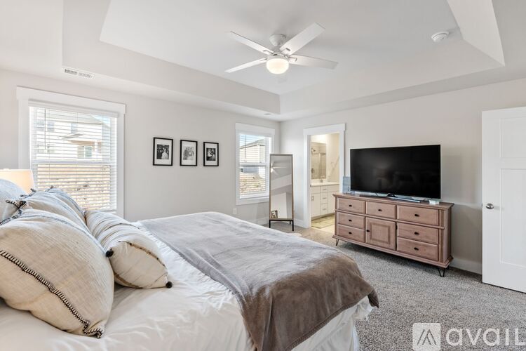 A bedroom with a large bed and a television.