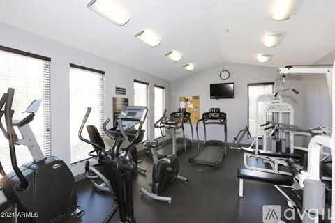 A well-equipped gym with treadmills, elliptical machines, and other exercise equipment.