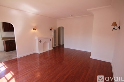 A room with wooden floors and white walls.