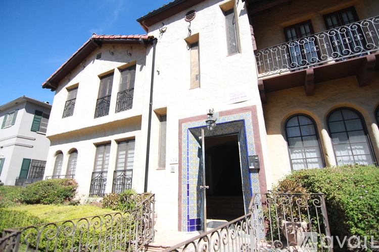 A white building with a blue and white tiled doorway.