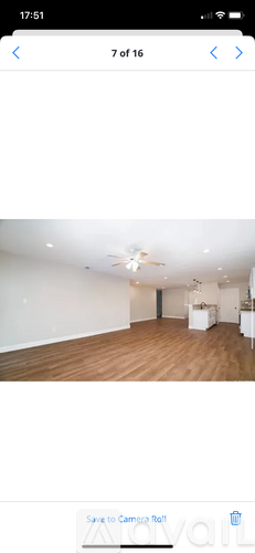 A room with wooden flooring and a ceiling fan.