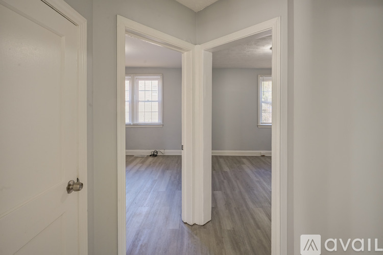 A room with a white door and a window.