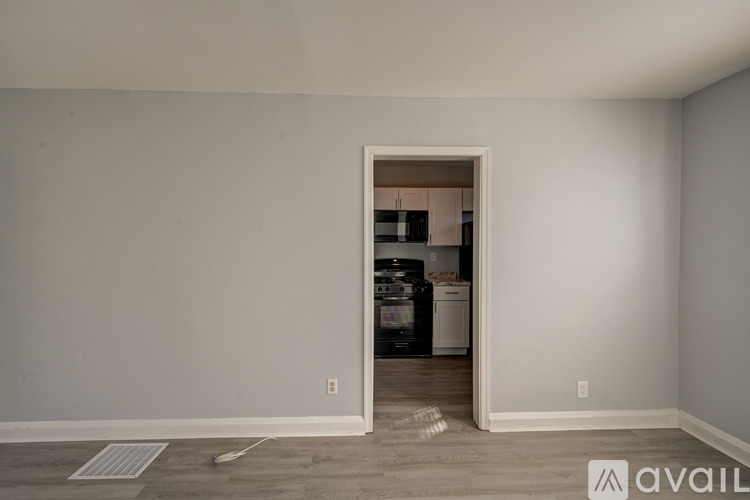 A room with a doorway leading to a laundry room.