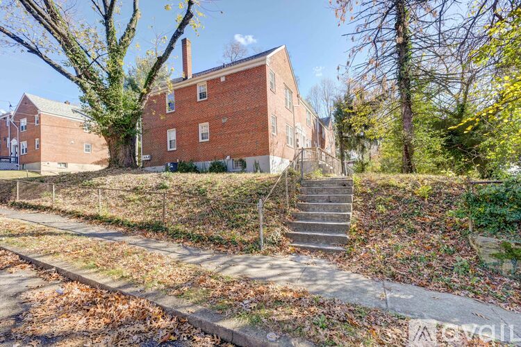 A brick building with a tree in front of it.