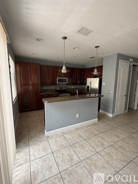 A kitchen with brown cabinets and a white island.