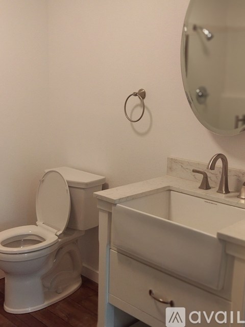 A toilet and sink in a bathroom.