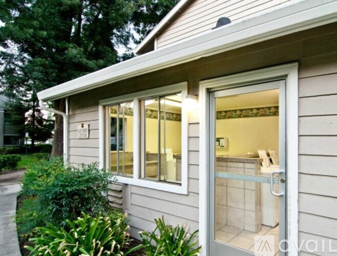 A house with a window and a door is for sale.