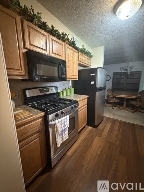 A kitchen with wooden cabinets and a black stove top oven.