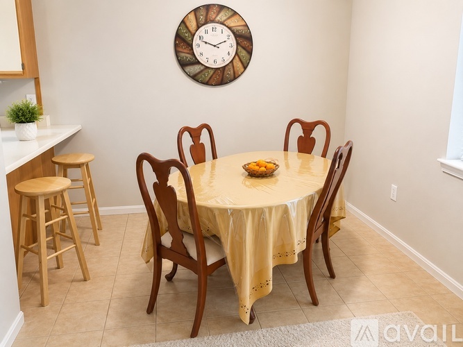 A dining room with a round table set for six.